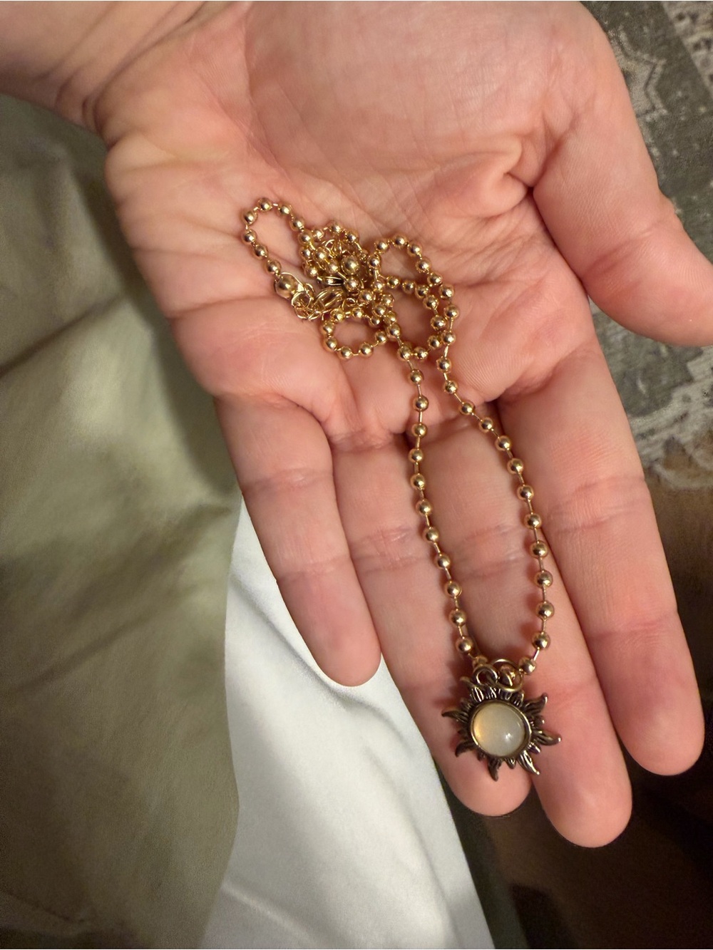 Gold Sunburst Pendant Necklace with Cream Stone
